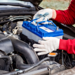 Mechanic replacing a car battery