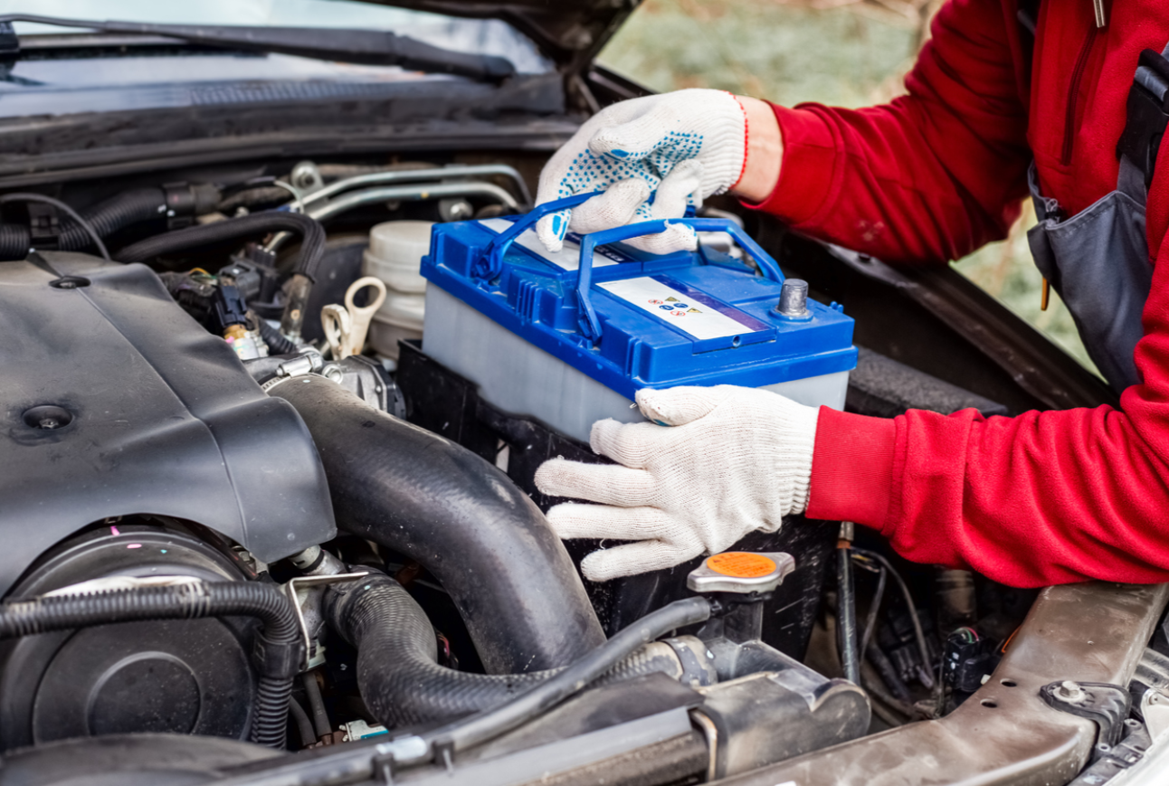 Mechanic replacing a car battery